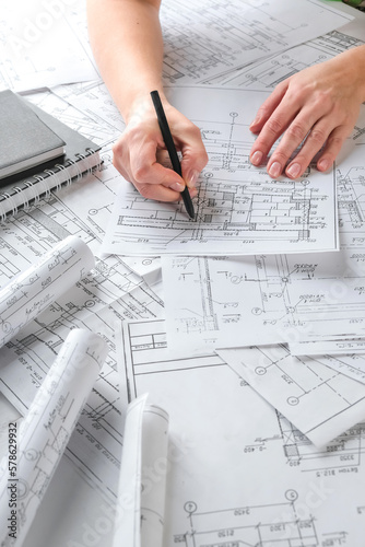 Architects concept, engineer architect designer freelance work on start-up project drawing, construction plan architect design working drawing sketch plans blueprints and making construction model