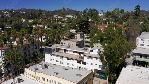 Aerial reverse pullback shot of Hollywood Hills apartments in Los Angeles, California. 4K