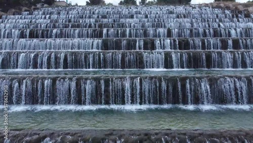 Man made beautiful large waterfall with many stairs.  photo