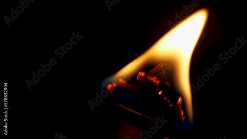 Flame on a candle with wood wick macro slow motion