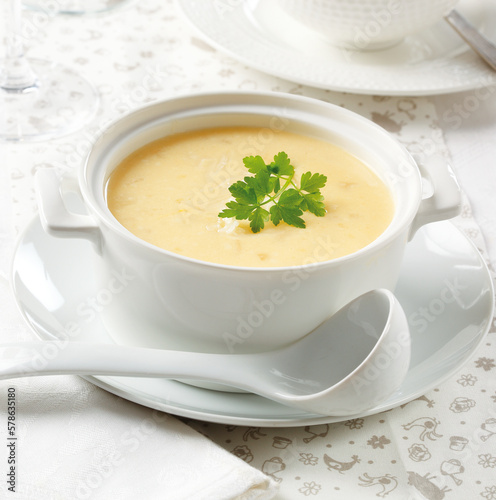 bowl with cheese soup decorated with parsley
