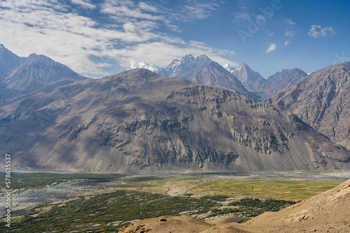 Scenic landscape view of Panj river valley in Wakhan Corridor with snow-capped Hindu Kush mountain range in Afghanistan near Langar, Gorno-Badakshan, Tajikistan Pamir