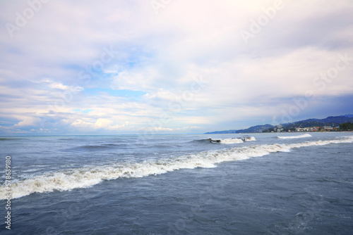 Picturesque view of sea with waves on cloudy day