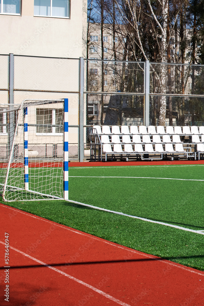 Obraz premium Green soccer field behind the fence closeup