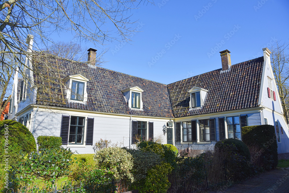 Amsterdam, Netherlands. February 2023. The wooden facades of the houses in Broek in Waterland. Amsterdam, Netherlands. February 2023. The wooden facades of the houses in Broek in Waterland.