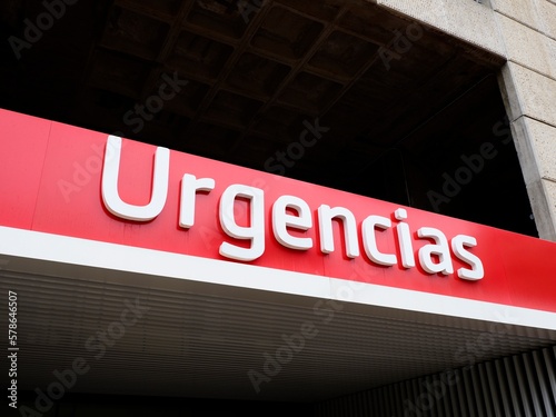 Bright red hospital emergency Urgencias poster in Valencia, Spain