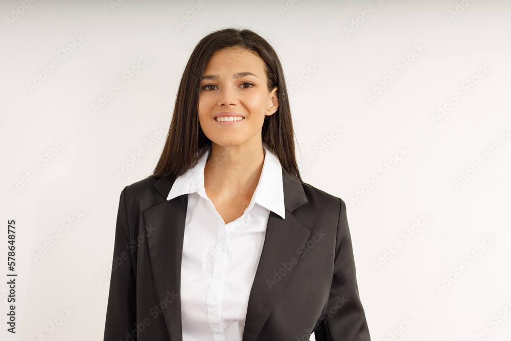 Portrait of happy smiling brunette girl dressed in white shirt and black jacket. Beautiful model on isolated white background. Studio shot of young attractive woman in business suit. Portrait of happy smiling brunette girl dressed in white shirt and black jacket. Beautiful model on isolated white background. Studio shot of young attractive woman in business suit.