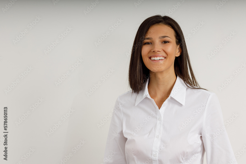 Portrait of happy smiling brunette girl dressed in white shirt. Beautiful model on isolated white background. Studio shot of young attractive woman in business suit. Portrait of happy smiling brunette girl dressed in white shirt. Beautiful model on isolated white background. Studio shot of young attractive woman in business suit.