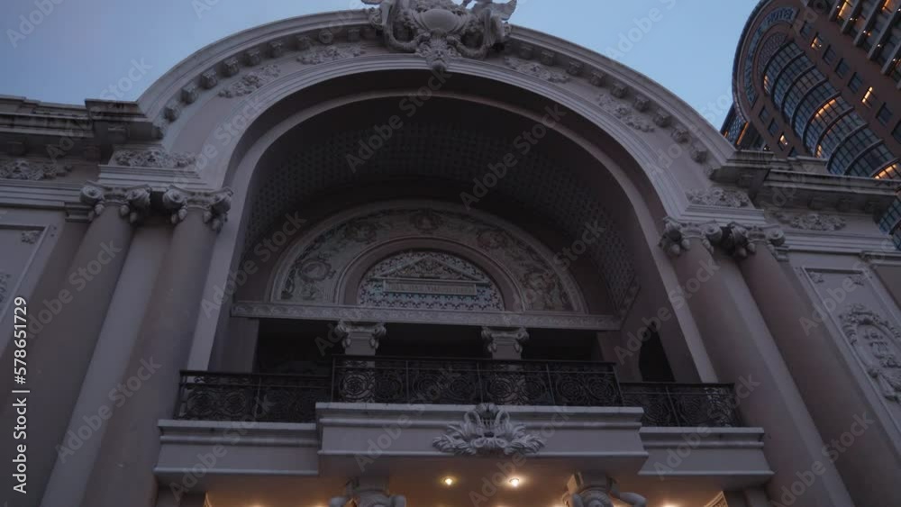 Looking Up On Arched Entrance Of Municipal Theatre Of Ho Chi Minh City At Dusk In Vietnam. low angle, tilt-up
