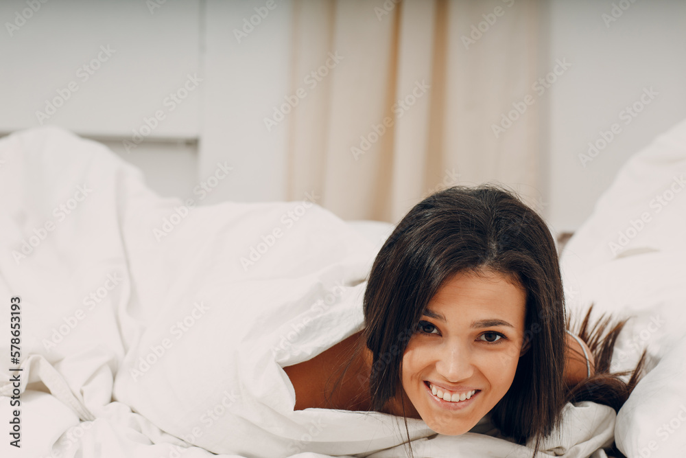 Healthy young woman dressing nightie lying on bed in bedroom. Healthy young woman dressing nightie lying on bed in bedroom.