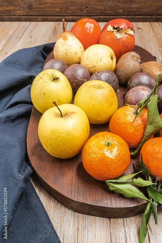 Wooden table full of fresh colorful fruits. Healthy eating and lifestyle