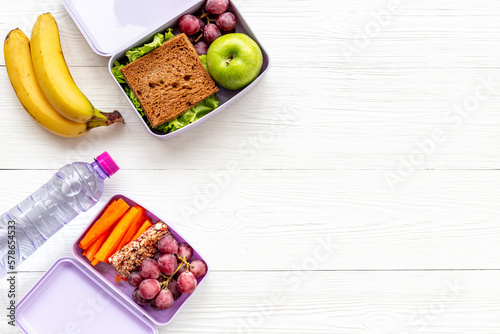 Healthy snacks and vegetables in lunch boxes. Top view