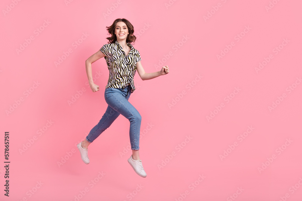 Full size profile photo of crazy satisfied girl jumping run empty space isolated on pink color background
