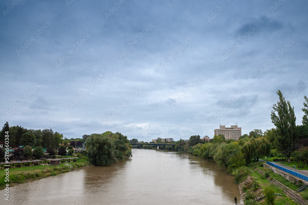 Panorama of the Mures river and riverbank in Arad, Romania, during a cold autumn rainy afternoon. Arad is a major romanian city in the north of the country.