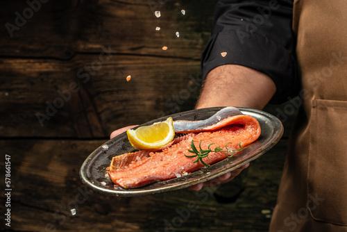 prepares fresh salmon fish, Raw fish trout steak with spices and herbs. place for text