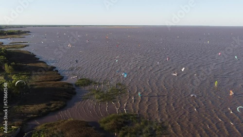 Aerial view over Rio de la Plata river and all kite surfers at sunset in Buenos Aires Argentina