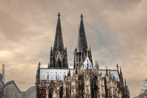 Cologne Cathedral seen from afar with blue sky. Cologne Cathedral, or Kolner Dom, is the main landmark of Cologne and a catholic church in Germany.