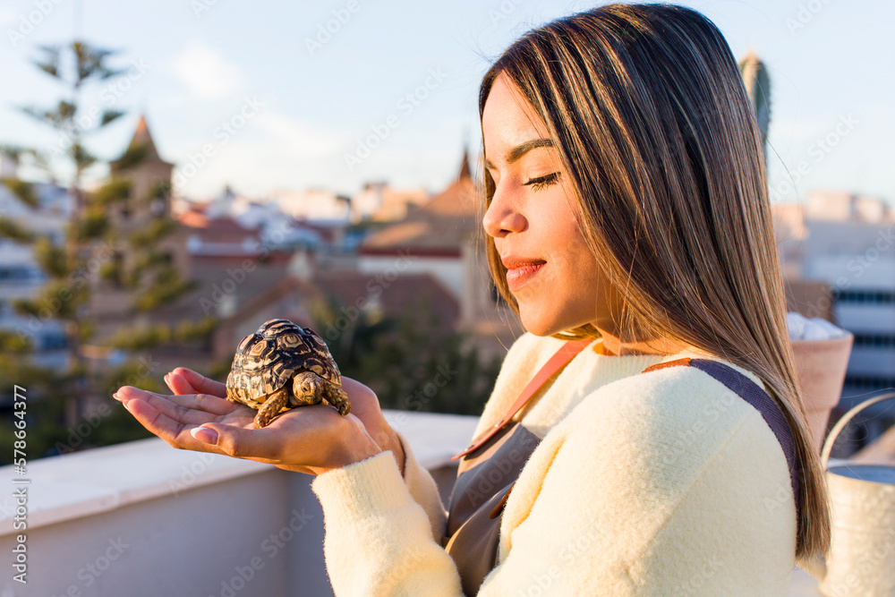 pretty latin woman with a tortoise pet pretty latin woman with a tortoise pet