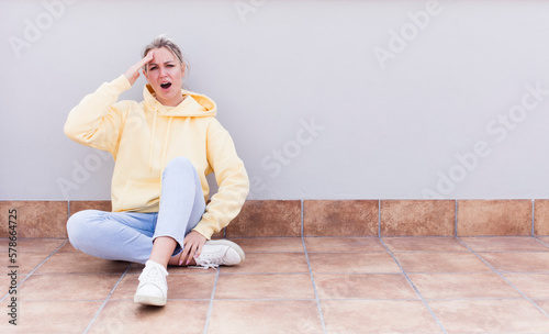 pretty caucasian sitting  woman looking happy, astonished and surprised, smiling and realizing amazing and incredible good news