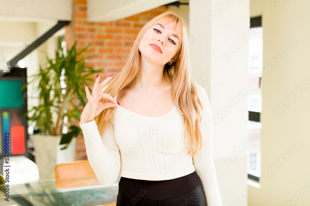 young pretty woman looking arrogant, successful, positive and proud, pointing to self. home interior young pretty woman looking arrogant, successful, positive and proud, pointing to self. home interior