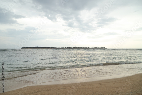 Fototapeta Naklejka Na Ścianę i Meble -  Lombok and Gili Air islands, overcast, cloudy day, sky and sea. Sunset, sand beach.