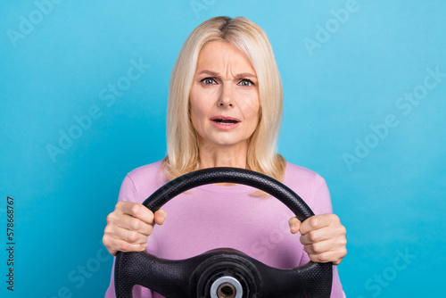 Photo of worried nervous lady wear stylish clothes drive vehicle new unknown road isolated on blue color background