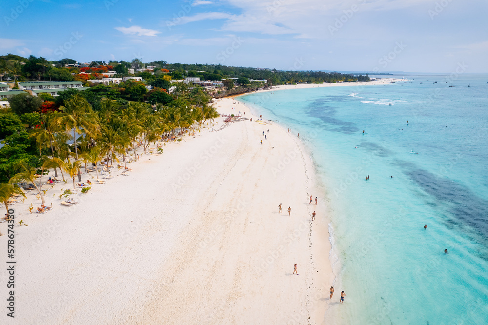 The picturesque Nungwi beach in Zanzibar, Tanzania is showcased in a toned aerial view image, highlighting the luxury resort and turquoise ocean waters.