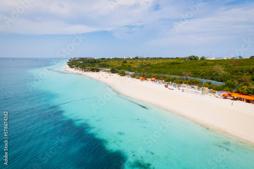 The picturesque Nungwi beach in Zanzibar, Tanzania is showcased in a toned aerial view image, highlighting the luxury resort and turquoise ocean waters. © Sebastian