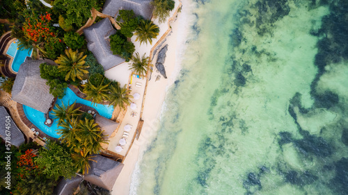 The turquoise ocean water and the luxurious resort on Kiwengwa beach in Zanzibar, Tanzania, are captured in this gorgeous toned aerial view. The scenery is simply stunning, and it's a perfect destinat