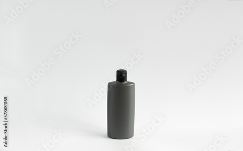 Black shampoo packaging mockup. Vertical empty plastic cosmetic package for man, isolated on white background. Container of conditioner, hair rinse.