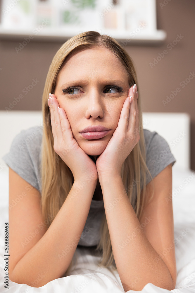 Dissatisfied blond lady woman wearing pajama hoe clothes girl in bad mood after nightmare girl in bedroom. Dissatisfied blond lady woman wearing pajama hoe clothes girl in bad mood after nightmare girl in bedroom.