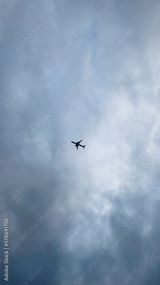 The plane is flying over a cloudy sky. The plane is flying over a cloudy sky.