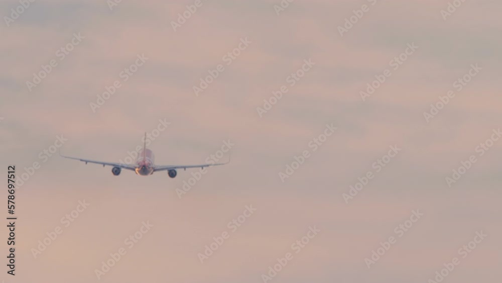 Jet airplane take off at sunset. Aircraft climb. Departure flight. Airliner silhouette, pink sky background. Travel concept Jet airplane take off at sunset. Aircraft climb. Departure flight. Airliner silhouette, pink sky background. Travel concept