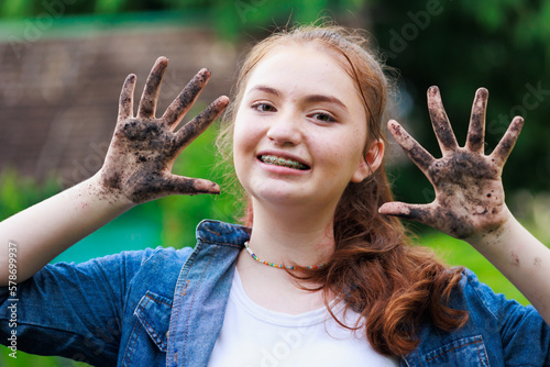 Kid show dirty hand. Cute girls show dirty hands and smiling face in farm school. learning at outdoors farm.