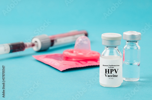 The Drug vial Human Papillomavirus : Hpv vaccine and condom with sample blood for test in blood tube. photo