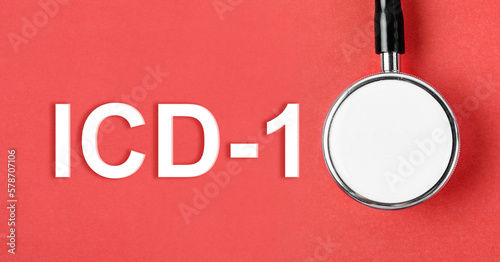 The ICD-10 or International Classification of Diseases and Related Health Problem 10th Revision text and medical stethoscope on red background. photo