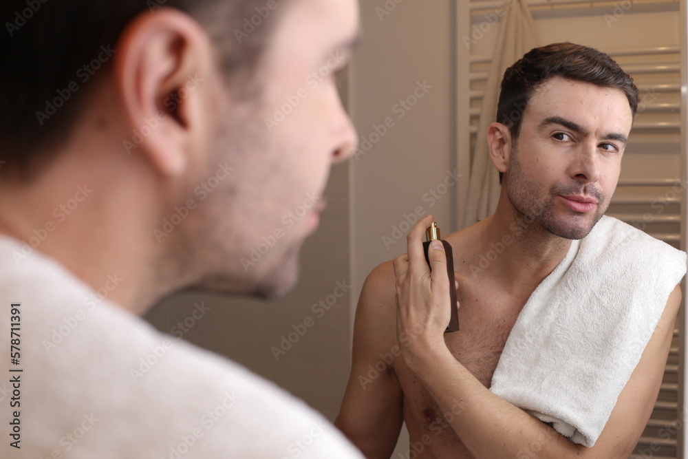 Fototapeta premium Man using perfume in the bathroom