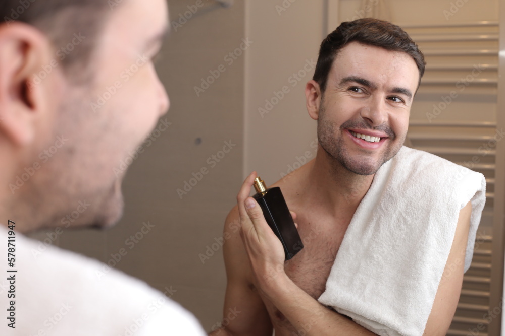Fototapeta premium Man using perfume in the bathroom