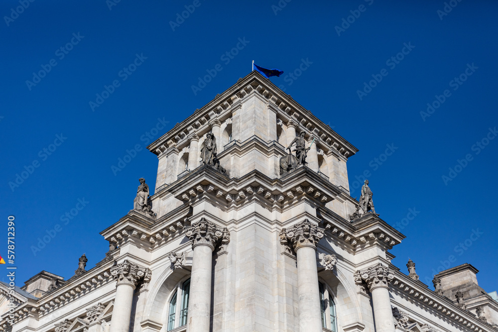 Looking up at classical government building with clear sky