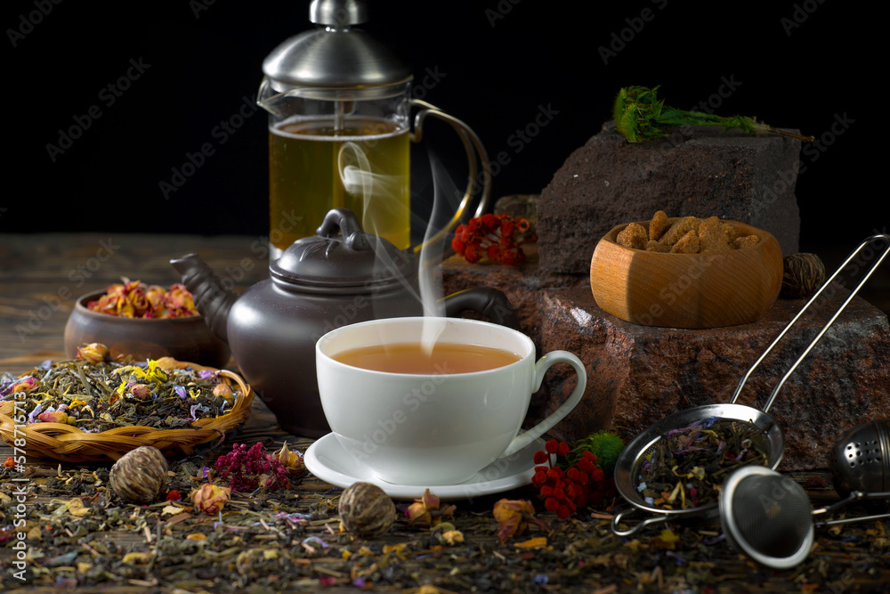 Sweet, hot tea with dry tea leaves, on an old background. Sweet, hot tea with dry tea leaves, on an old background.
