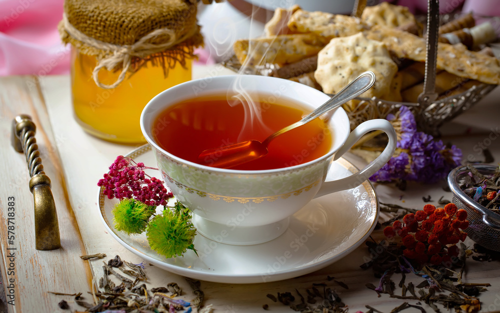 Sweet, hot tea with dry tea leaves, on an old background. Sweet, hot tea with dry tea leaves, on an old background.