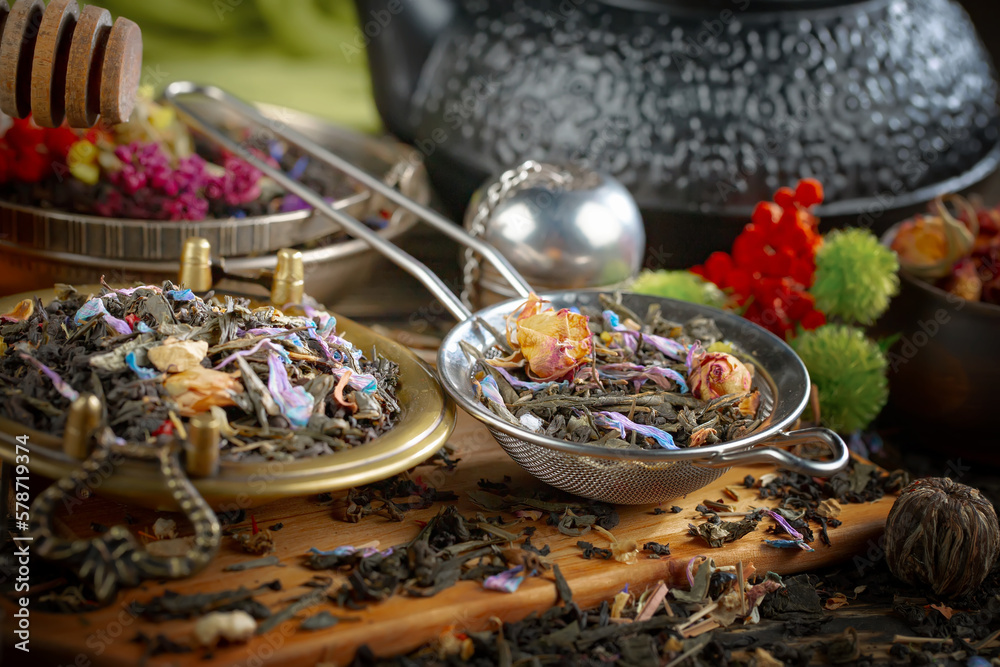 Dried tea leaves in a spoon, on an old background. Dried tea leaves in a spoon, on an old background.