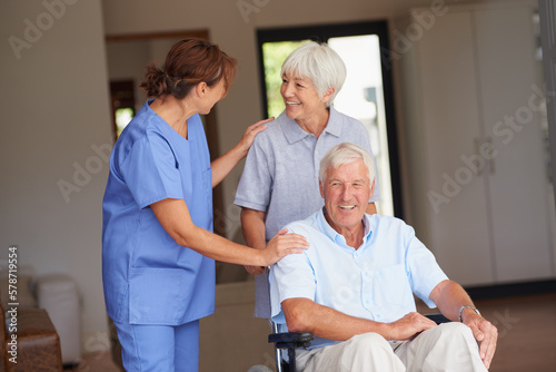 Hell be on his feet in no time. a nurse giving good news to her senior patient and his wife.
