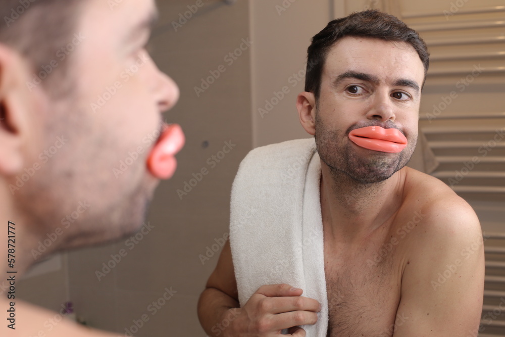 Fototapeta premium Comedic image of man looking at his enlarged lips 