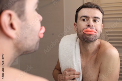 Photos Comedic image of man looking at his enlarged lips