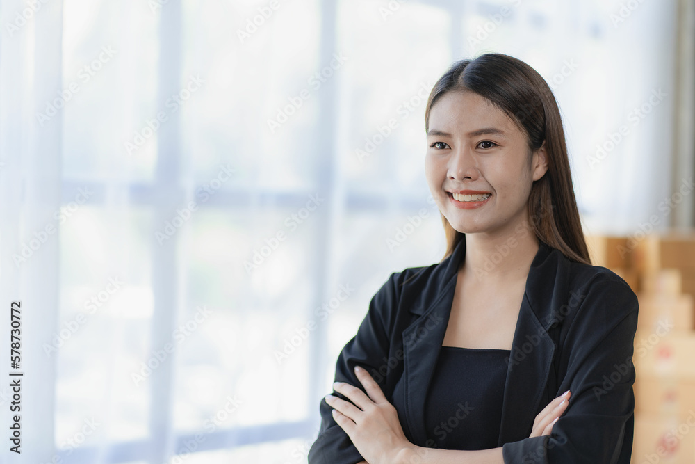 Asian young woman working from home with boxes, checking orders and preparing to deliver packages, SME online business concept Asian young woman working from home with boxes, checking orders and preparing to deliver packages, SME online business concept