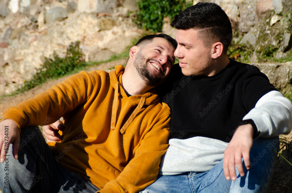 Couple of two men are shown happy and united while laughing. Homosexuality and LGBTQ+ concept. Couple of two men are shown happy and united while laughing. Homosexuality and LGBTQ+ concept.