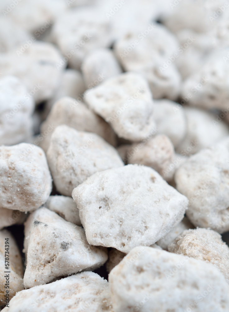 Porous white volcanic rock. Lava stone, pumice stone, or volcanic pumice with distinctive pores Porous white volcanic rock. Lava stone, pumice stone, or volcanic pumice with distinctive pores