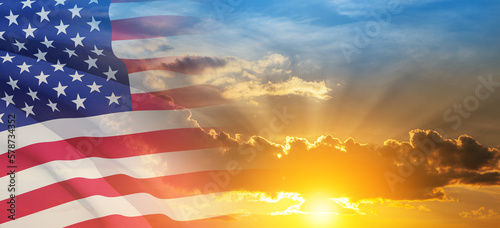 United States of America flag on sky at sunset or sunrise background.