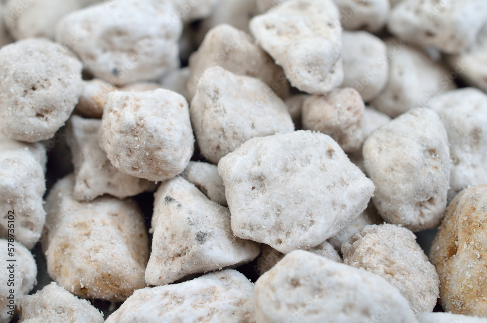 Porous white volcanic rock. Lava stone, pumice stone, or volcanic pumice with distinctive pores Porous white volcanic rock. Lava stone, pumice stone, or volcanic pumice with distinctive pores